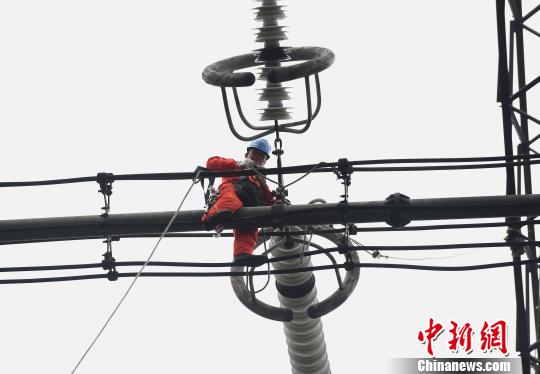 圖為電力工人在70多米高空作業(yè)，為特高壓復(fù)奉線重慶段進行八年來首次大修。　周毅 攝